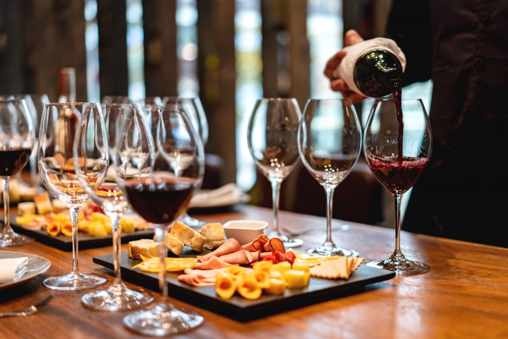 Close-up on a sommelier serving glasses of winetasting event